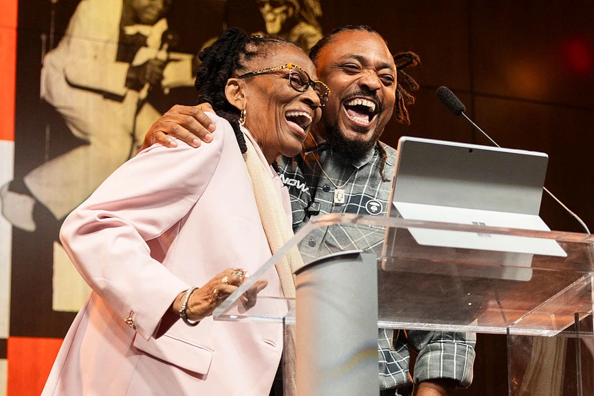 Elizabeth Montano and Machel Montano speak during the 'Journey Of A Soca King' exhibition.'