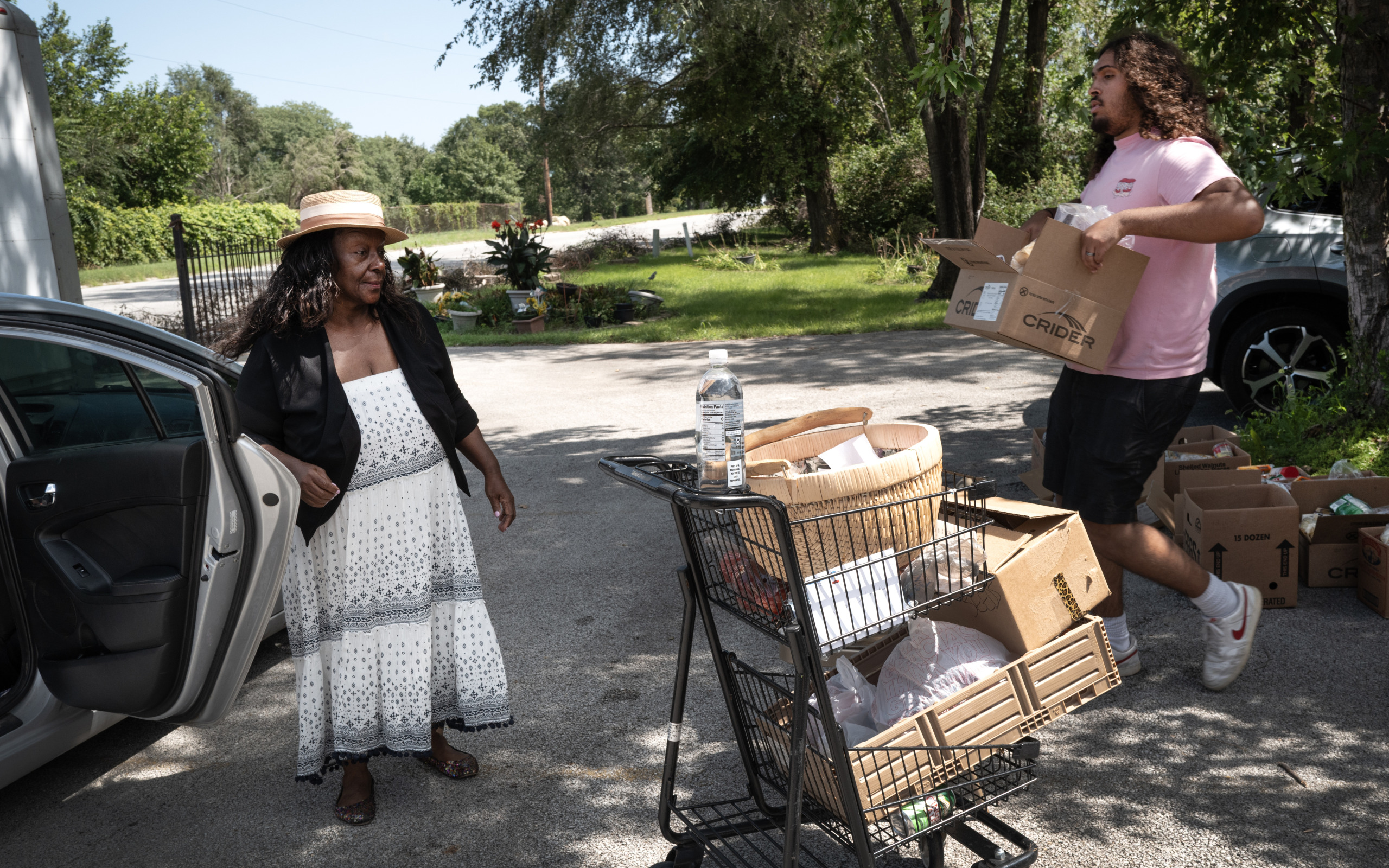 Pastor Valerie Clarke (L) and Connor Taylor of the Gospel Truth Apostolic Ministry distribute food to residents out side of their church on August 20, 2026 in Gary, Indiana. (Photo by Scott Olson/Getty Images)