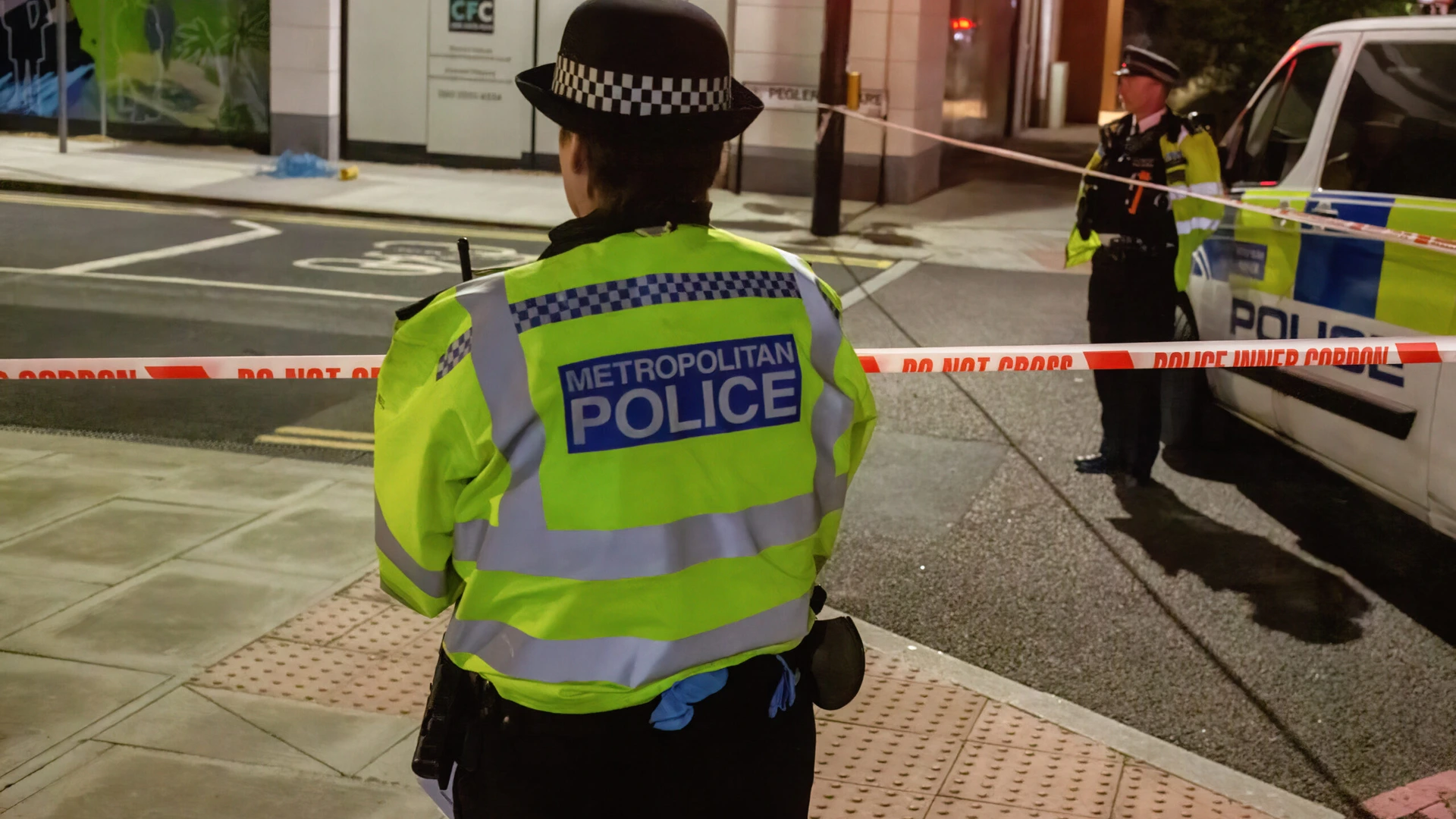 An officer stands next to a police cordon close to where