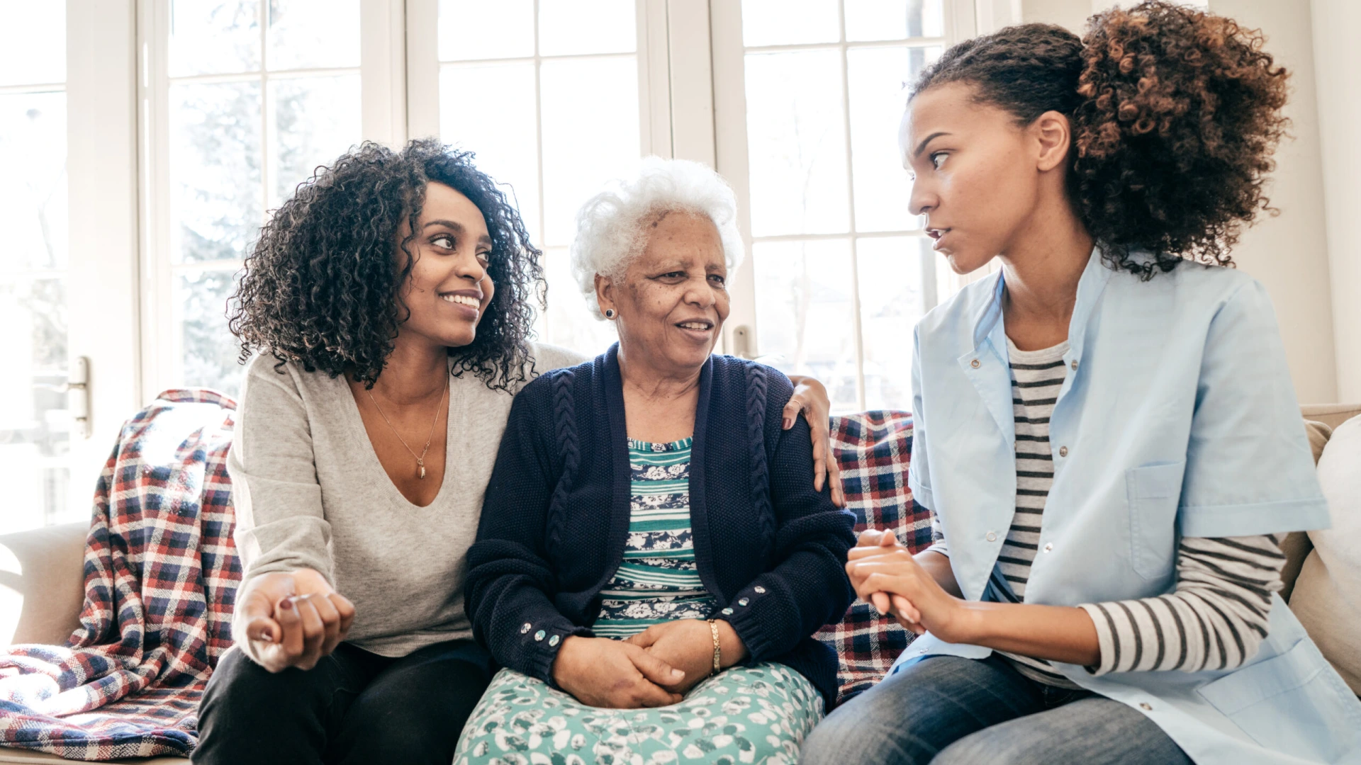 Nurse visiting senior lady at home