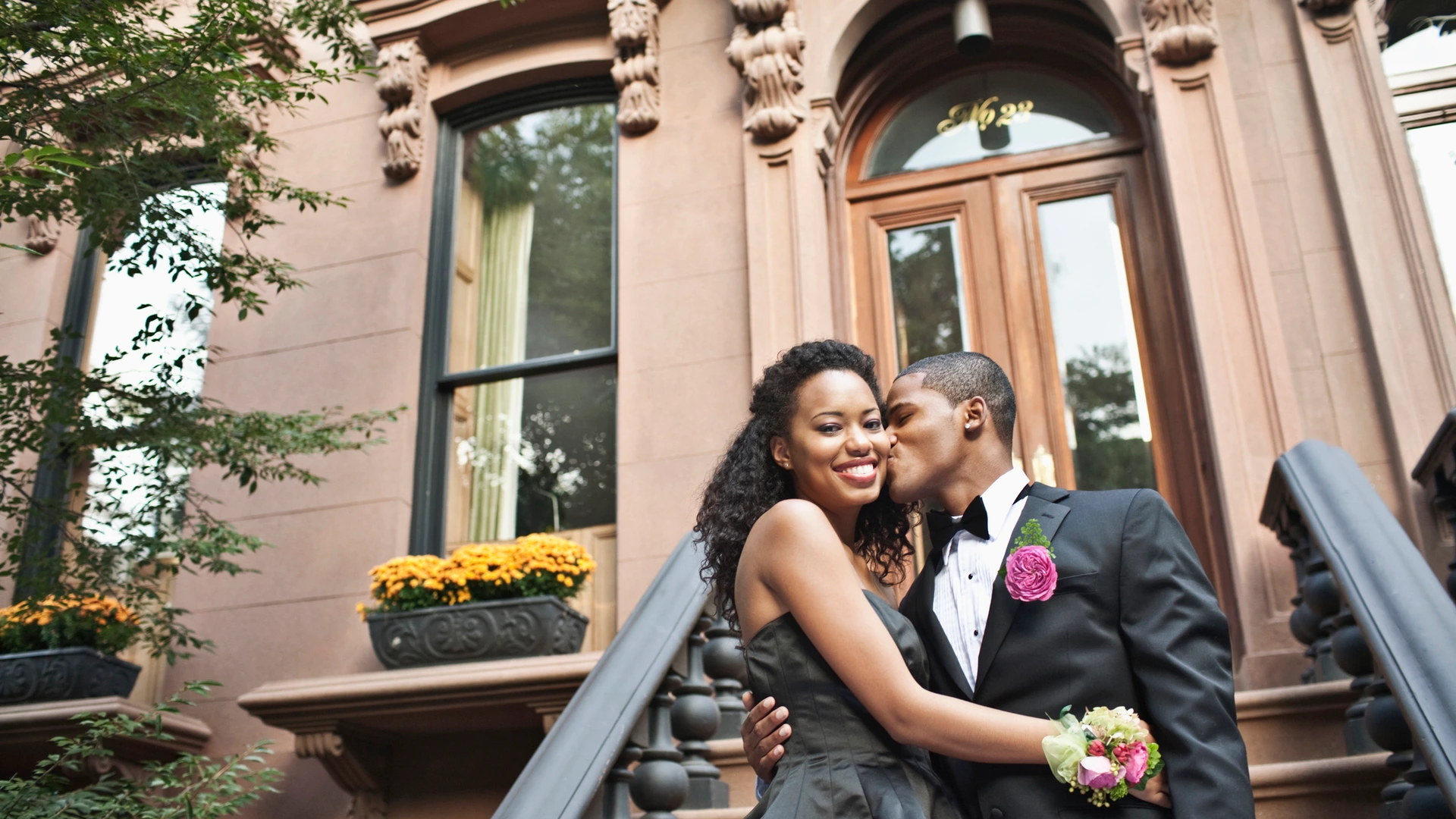 Couple going to prom on front stoop