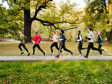 A group of runners racing through the park