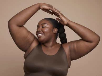 Studio shot of smiling young woman with braided hair