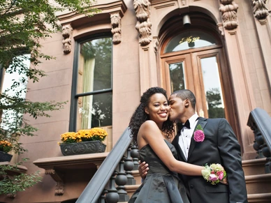 Couple going to prom on front stoop